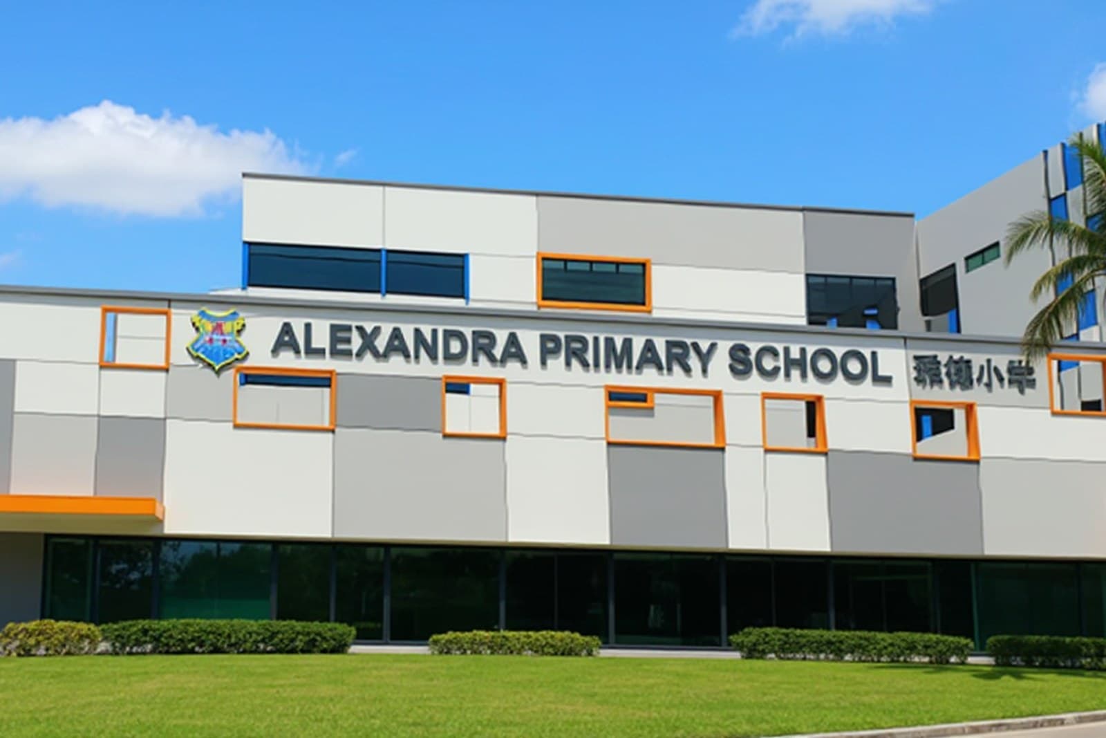 Alexandra Primary School, a grey and white building with orange window trim, under a clear blue sky